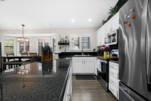 Dining room, Interior, Kitchen, Pendant Lights, Recessed Lighting, Stainless Steel Appliances, Wood Texture Flooring