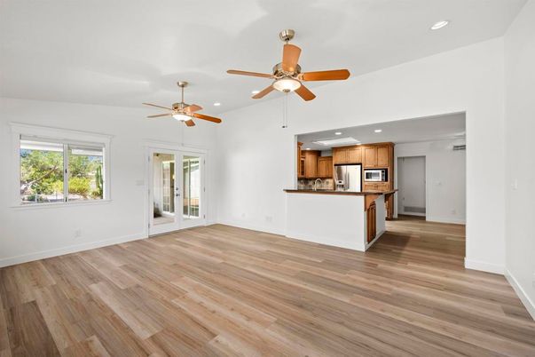 Empty room, Interior, Kitchen, Recessed Lighting, Stainless Steel Appliances, Wood Texture Flooring
