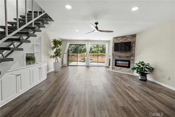 Empty room, Fireplace, Interior, Recessed Lighting, Stone Walls, Wood Texture Flooring