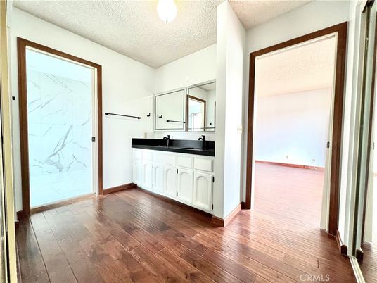 Bathroom, Dual Sink Vanities, Empty room, Interior, Marble Walls, Wood Texture Flooring