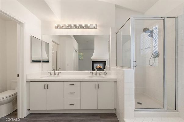 Bathroom, Dual Sink Vanities, Fireplace, Glass Shower, Interior, Wood Texture Flooring