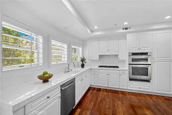 Interior, Kitchen, Recessed Lighting, Stainless Steel Appliances, Tile Countertops, Wood Texture Flooring