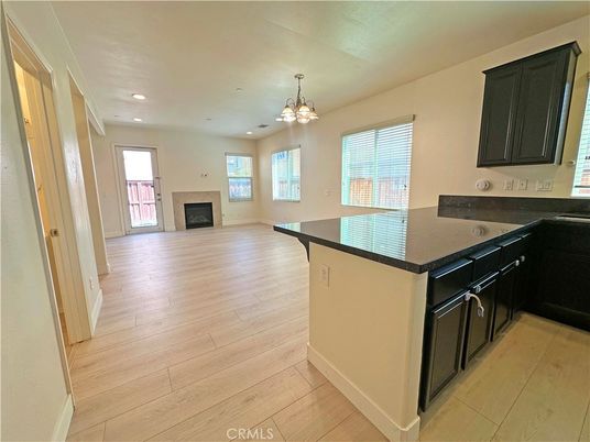 Chandelier, Empty room, Fireplace, Interior, Kitchen, Recessed Lighting, Wood Texture Flooring