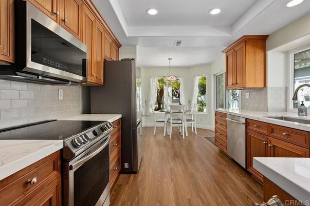 Dining room, Interior, Kitchen, Pendant Lights, Recessed Lighting, Stainless Steel Appliances, Wood Texture Flooring