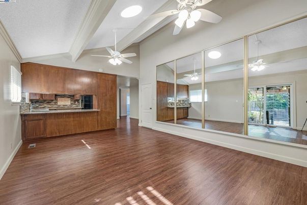 Empty room, Interior, Kitchen, Recessed Lighting, Stainless Steel Appliances, Wood Texture Flooring