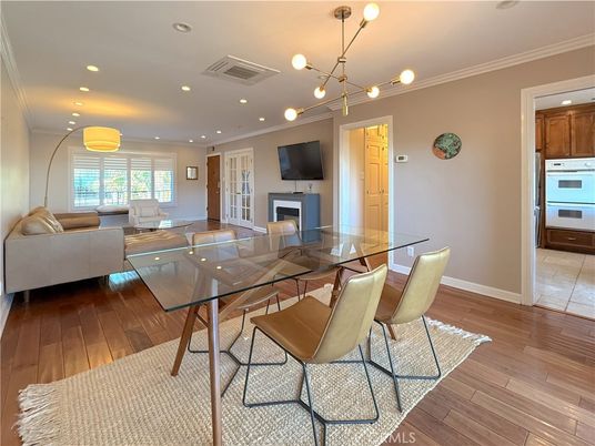 Dining room, Fireplace, Interior, Living room, Pendant Lights, Recessed Lighting, Wood Texture Flooring