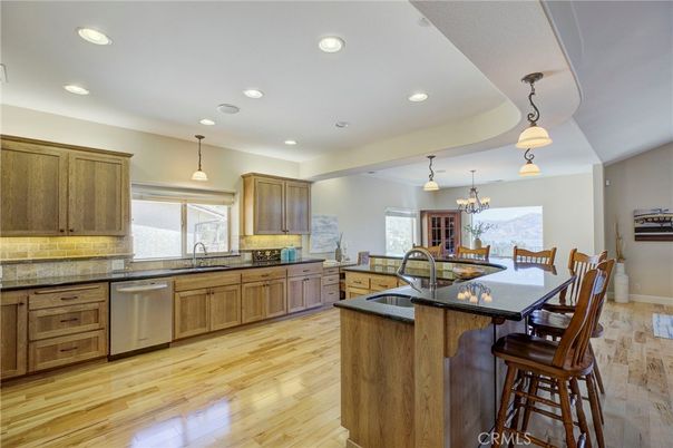 Chandelier, Dining room, Interior, Kitchen, Pendant Lights, Recessed Lighting, Stainless Steel Appliances, Wood Texture Flooring