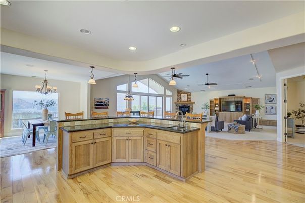Chandelier, Dining room, Fireplace, Interior, Living room, Pendant Lights, Recessed Lighting, Wood Texture Flooring