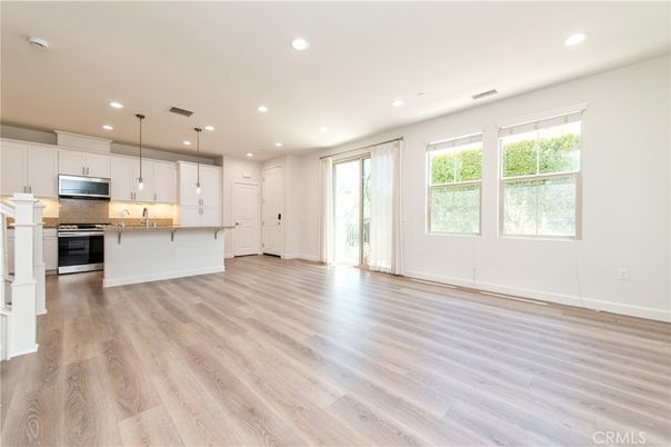 Empty room, Interior, Kitchen, Pendant Lights, Recessed Lighting, Stainless Steel Appliances, Wood Texture Flooring