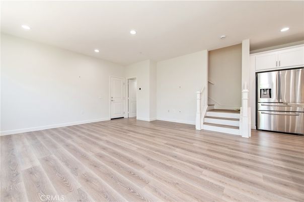 Empty room, Interior, Kitchen, Recessed Lighting, Stainless Steel Appliances, Wood Texture Flooring