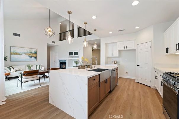 Dining room, Fireplace, Interior, Kitchen, Pendant Lights, Recessed Lighting, Stainless Steel Appliances, Wood Texture Flooring