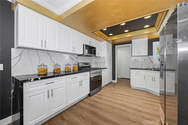 Interior, Kitchen, Marble Walls, Recessed Lighting, Stainless Steel Appliances, Wood Texture Flooring