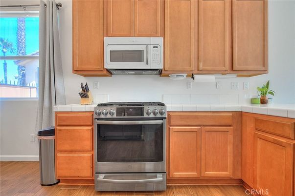 Interior, Kitchen, Stainless Steel Appliances, Tile Countertops, Wood Texture Flooring
