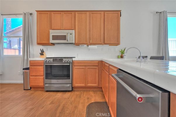 Interior, Kitchen, Stainless Steel Appliances, Tile Countertops, Wood Texture Flooring
