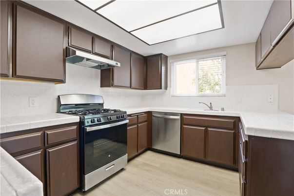Interior, Kitchen, Stainless Steel Appliances, Tile Countertops, Wood Texture Flooring
