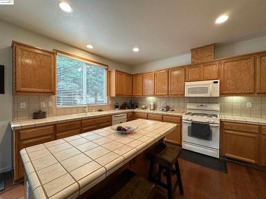 Interior, Kitchen, Recessed Lighting, Tile Countertops, Wood Texture Flooring