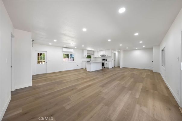 Empty room, Interior, Kitchen, Recessed Lighting, Stainless Steel Appliances, Wood Texture Flooring