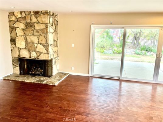 Empty room, Fireplace, Interior, Recessed Lighting, Stone Walls, Wood Texture Flooring