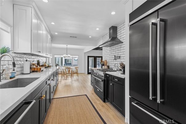 Chandelier, Dining room, Interior, Kitchen, Pendant Lights, Recessed Lighting, Stainless Steel Appliances, Stone Walls, Wood Texture Flooring