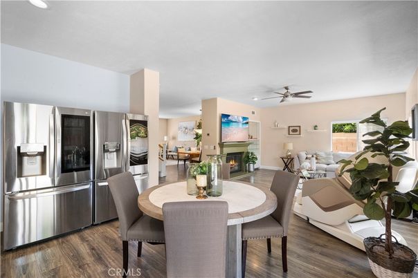 Dining room, Fireplace, Interior, Living room, Recessed Lighting, Stainless Steel Appliances, Wood Texture Flooring