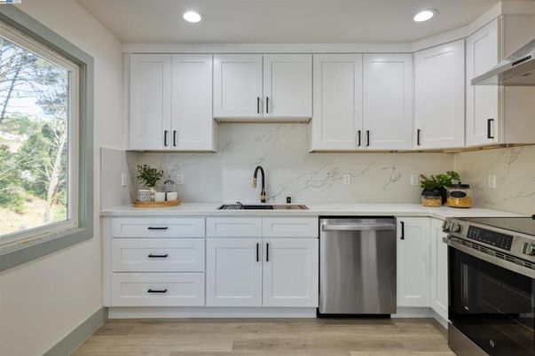Interior, Kitchen, Marble Walls, Recessed Lighting, Stainless Steel Appliances, Wood Texture Flooring