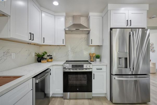 Interior, Kitchen, Marble Walls, Recessed Lighting, Stainless Steel Appliances, Wood Texture Flooring