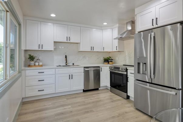 Interior, Kitchen, Marble Walls, Recessed Lighting, Stainless Steel Appliances, Wood Texture Flooring