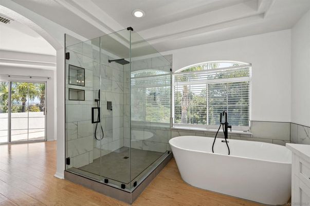 Bathroom, Free Standing Baths, Glass Shower, Interior, Marble Walls, Recessed Lighting, Wood Texture Flooring