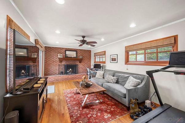 Fireplace, Fitness Equipment, Interior, Living room, Recessed Lighting, Stone Walls, Wood Texture Flooring