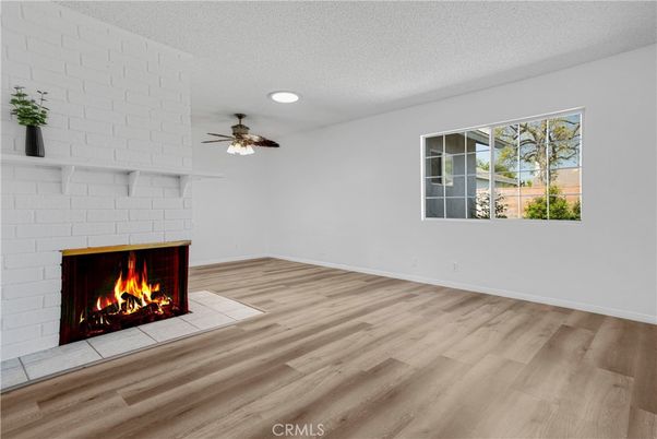 Empty room, Fireplace, Interior, Recessed Lighting, Stone Walls, Wood Texture Flooring