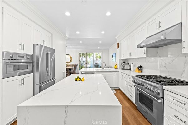 Interior, Kitchen, Marble Walls, Recessed Lighting, Stainless Steel Appliances, Wood Texture Flooring