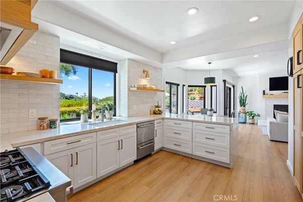 Fireplace, Interior, Kitchen, Pendant Lights, Recessed Lighting, Stainless Steel Appliances, Stone Walls, Wood Texture Flooring