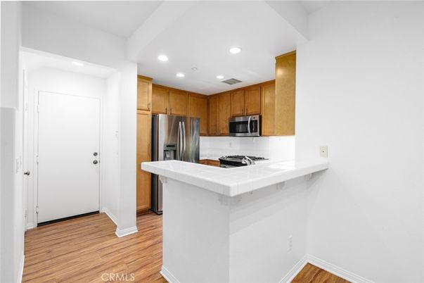 Interior, Kitchen, Recessed Lighting, Stainless Steel Appliances, Tile Countertops, Wood Texture Flooring