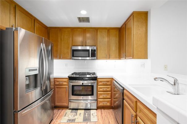 Interior, Kitchen, Recessed Lighting, Stainless Steel Appliances, Tile Countertops, Wood Texture Flooring