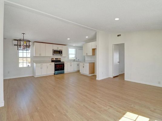 Empty room, Interior, Kitchen, Recessed Lighting, Stainless Steel Appliances, Wood Texture Flooring