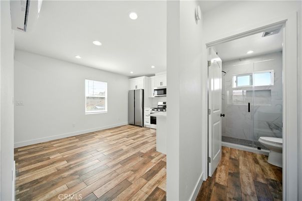 Bathroom, Glass Shower, Interior, Kitchen, Recessed Lighting, Stainless Steel Appliances, Wood Texture Flooring