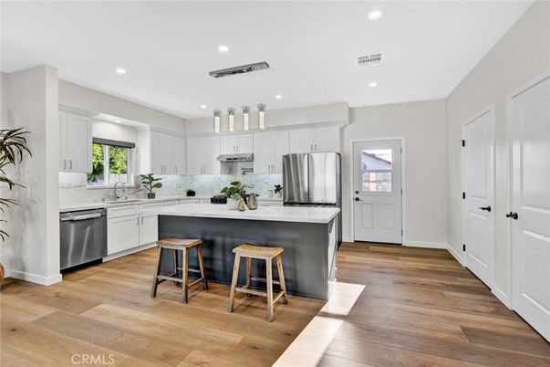 Interior, Kitchen, Marble Walls, Recessed Lighting, Stainless Steel Appliances, Wood Texture Flooring