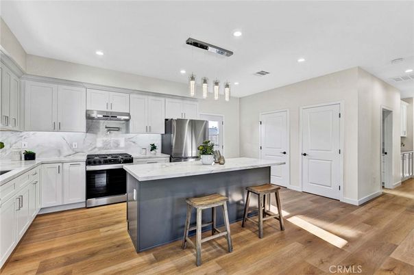 Interior, Kitchen, Marble Walls, Pendant Lights, Recessed Lighting, Stainless Steel Appliances, Wood Texture Flooring