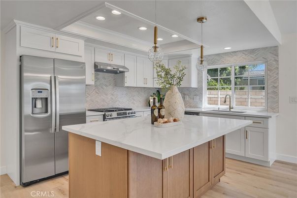 Interior, Kitchen, Marble Walls, Pendant Lights, Recessed Lighting, Stainless Steel Appliances, Wood Texture Flooring