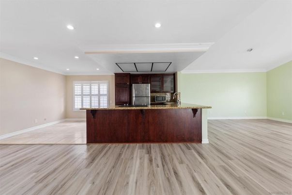 Empty room, Interior, Kitchen, Recessed Lighting, Stainless Steel Appliances, Wood Texture Flooring