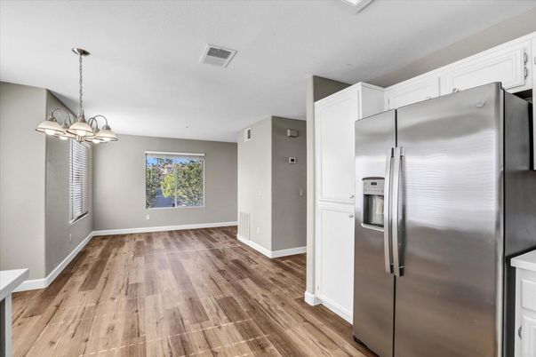 Empty room, Interior, Kitchen, Pendant Lights, Stainless Steel Appliances, Wood Texture Flooring