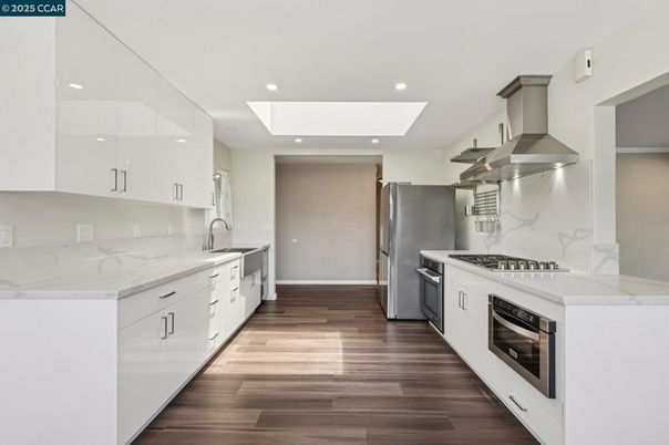 Interior, Kitchen, Marble Walls, Recessed Lighting, Stainless Steel Appliances, Wood Texture Flooring