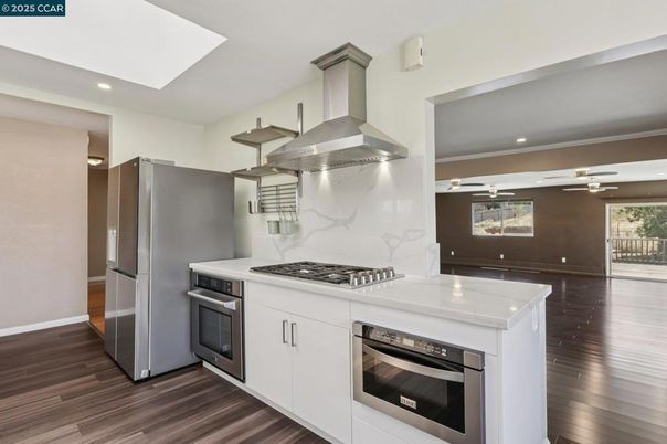 Interior, Kitchen, Marble Walls, Recessed Lighting, Stainless Steel Appliances, Wood Texture Flooring