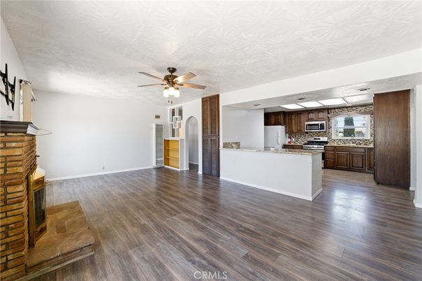 Empty room, Fireplace, Interior, Kitchen, Stainless Steel Appliances, Wood Texture Flooring