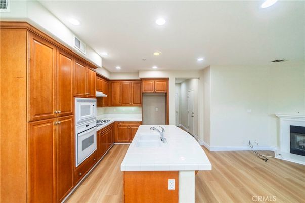 Fireplace, Interior, Kitchen, Recessed Lighting, Tile Countertops, Wood Texture Flooring