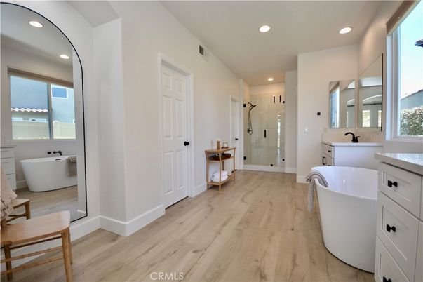 Bathroom, Free Standing Baths, Glass Shower, Interior, Recessed Lighting, Wood Texture Flooring