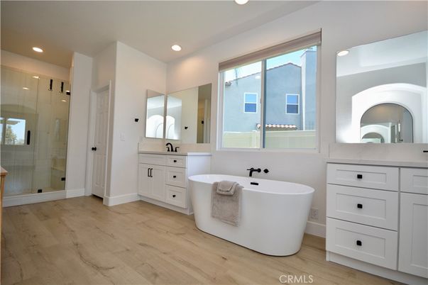Bathroom, Dual Sink Vanities, Free Standing Baths, Glass Shower, Interior, Recessed Lighting, Wood Texture Flooring