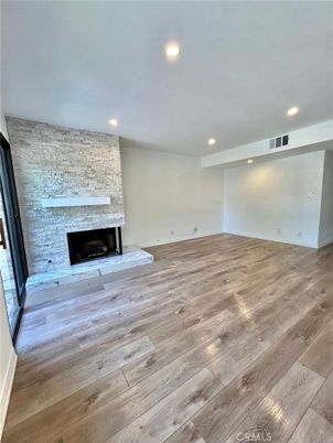 Empty room, Fireplace, Interior, Recessed Lighting, Stone Walls, Wood Texture Flooring