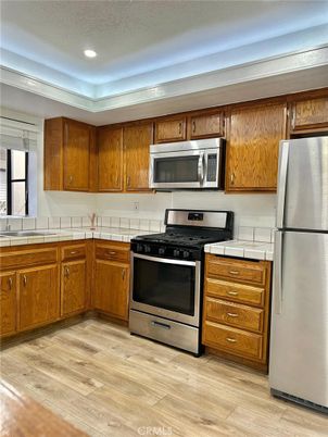 Interior, Kitchen, Recessed Lighting, Stainless Steel Appliances, Tile Countertops, Wood Texture Flooring