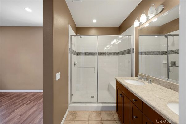Bathroom, Dual Sink Vanities, Glass Shower, Interior, Recessed Lighting, Wood Texture Flooring